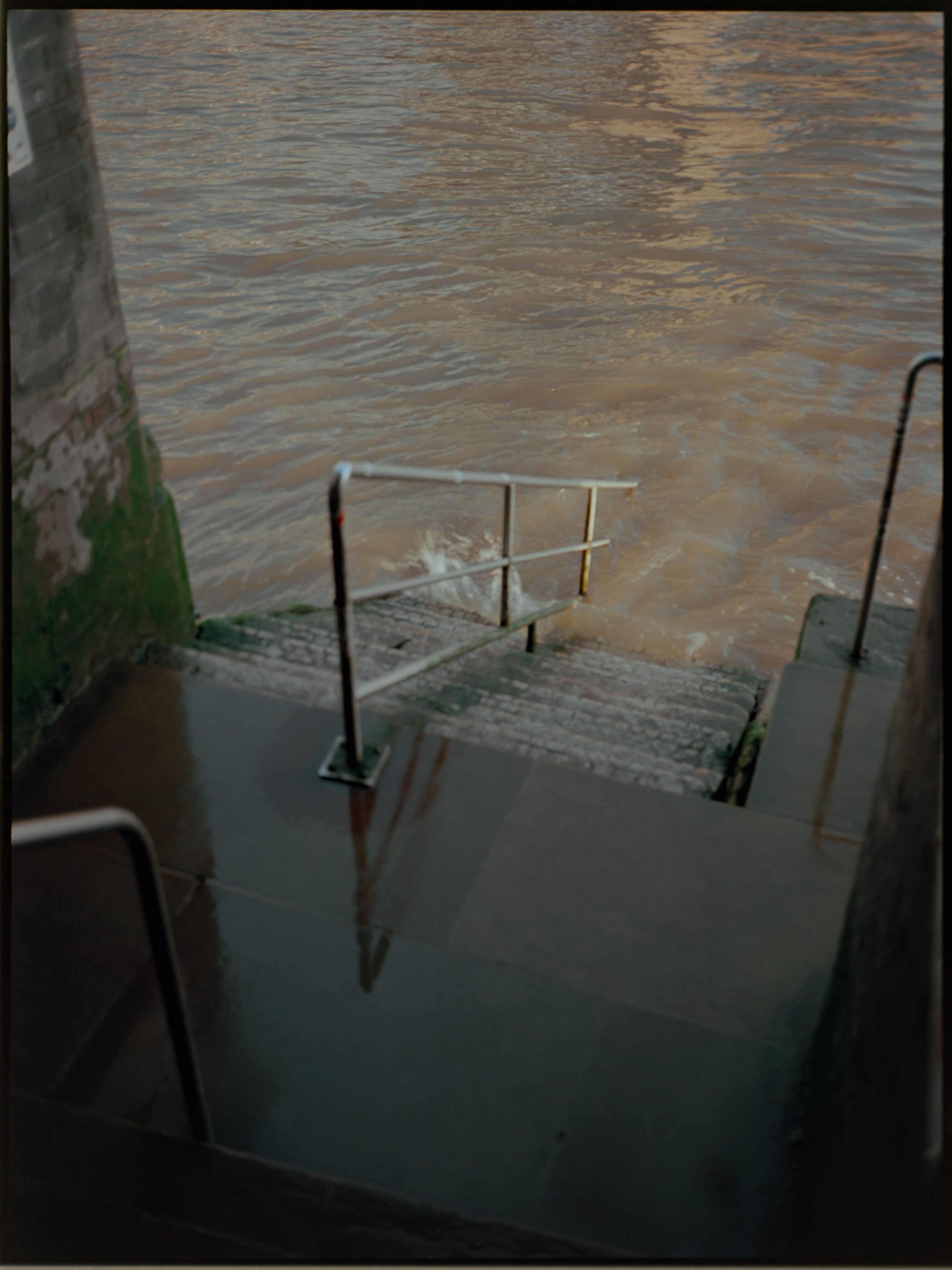 Thames river steps partially submerged at high tide — atmospheric London film photography