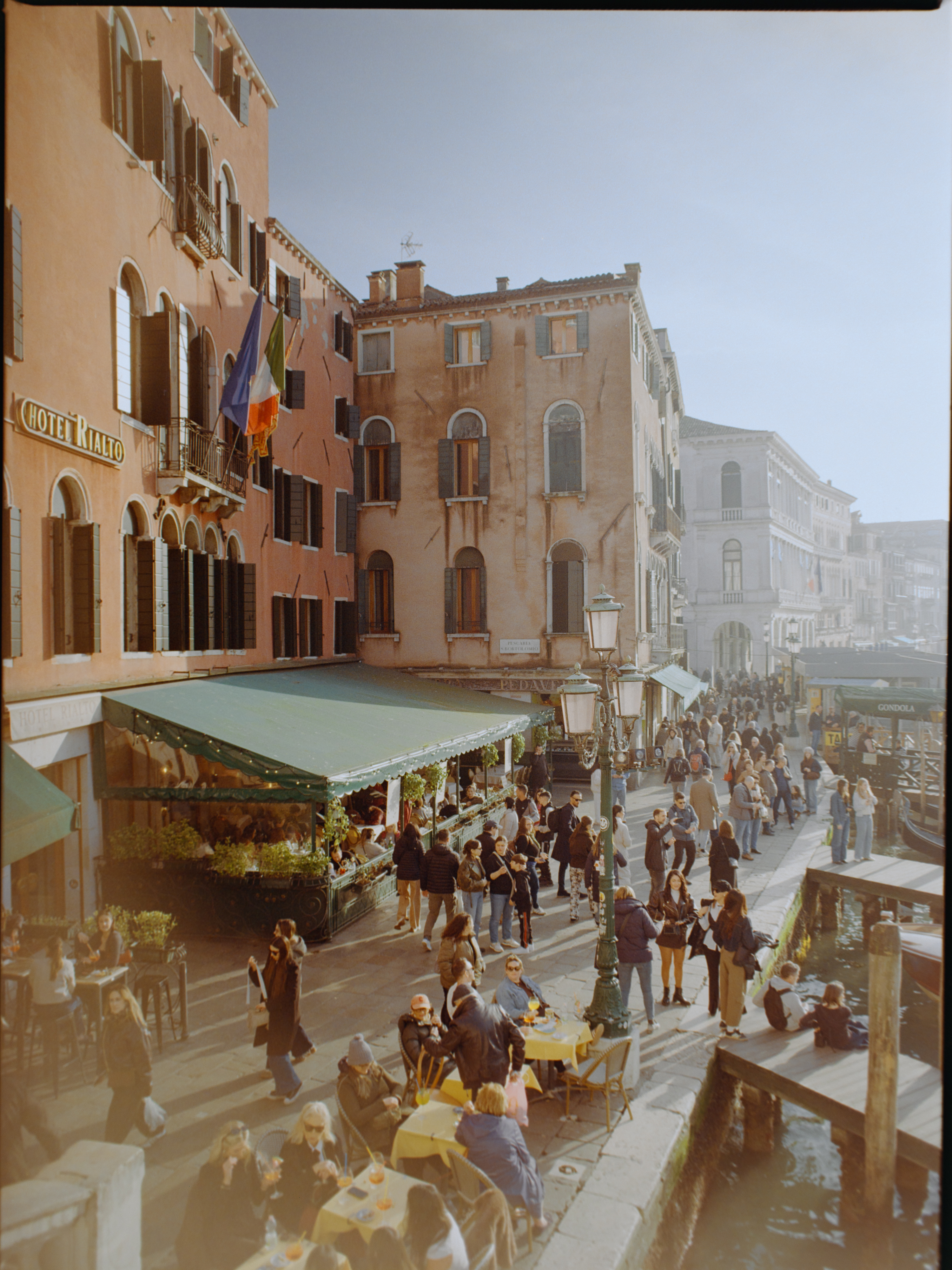 Elevated view from the bridge looking down the canal bank promenade — Venice on medium format film