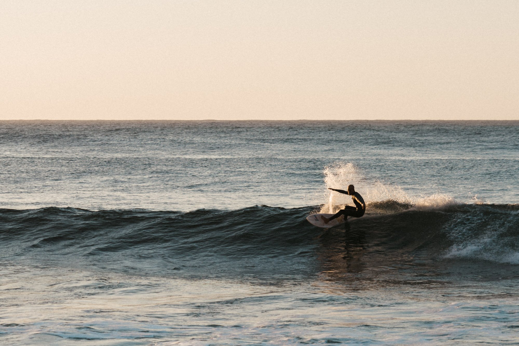 surfer cutting wave sunset commercial lifestyle photographer london
