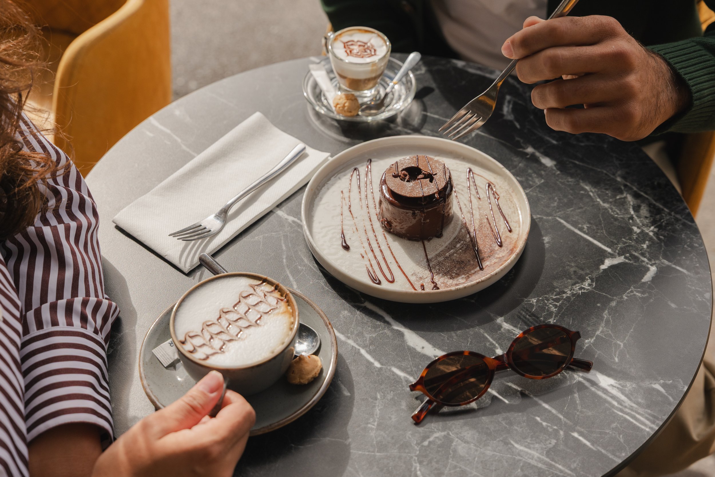 Chocolate fondant and cappuccino at boutique hotel cafe