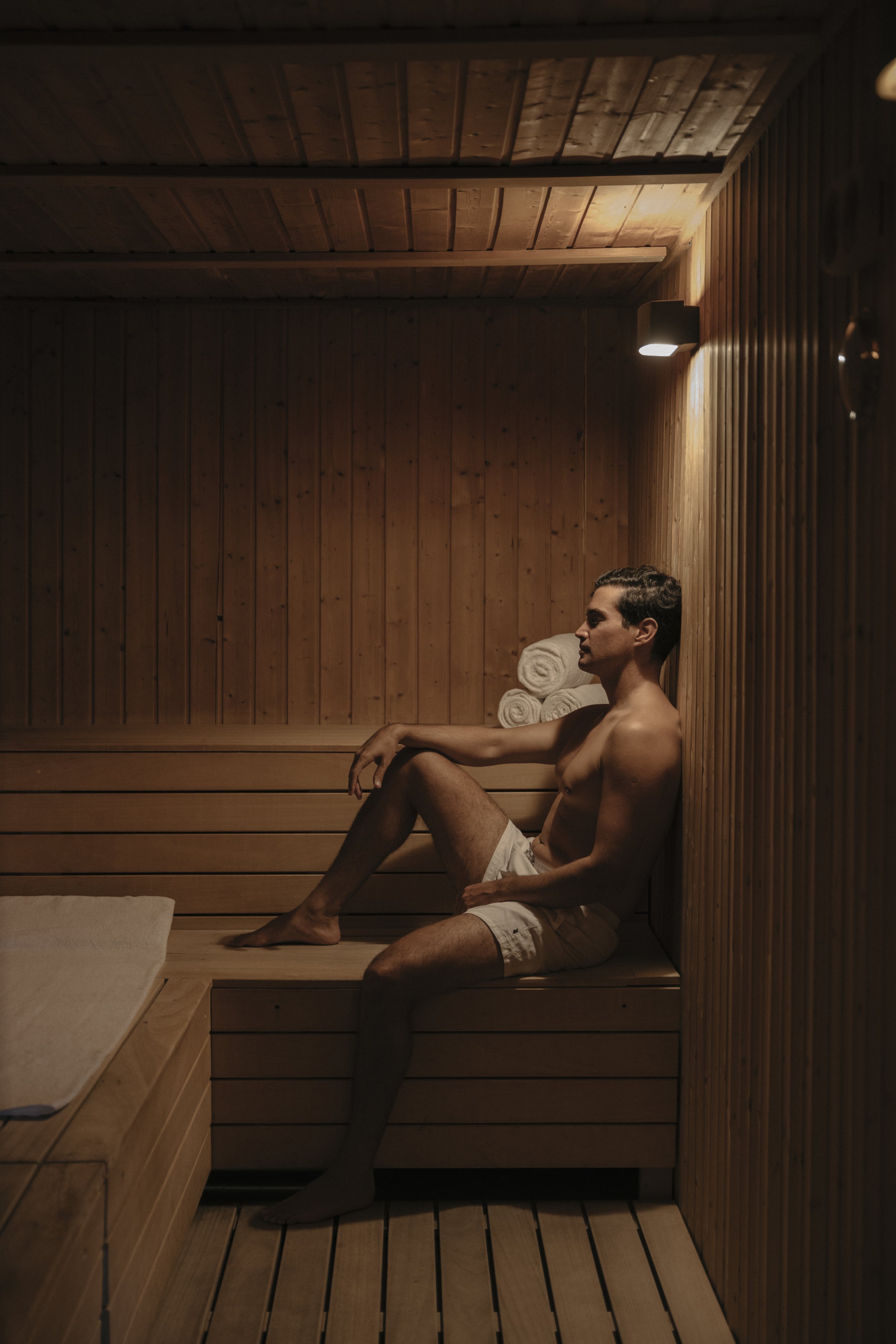 Man relaxing in cedar wood sauna wellness retreat