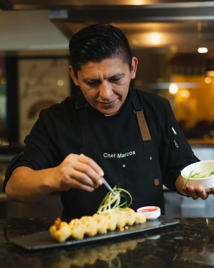 Restaurant chef plating food at Seadust Cancun
